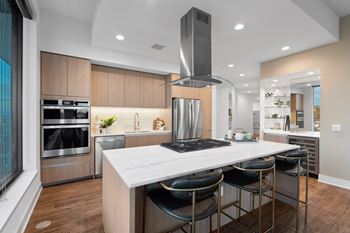 A kitchen with a stainless steel appliances and wooden cabinets